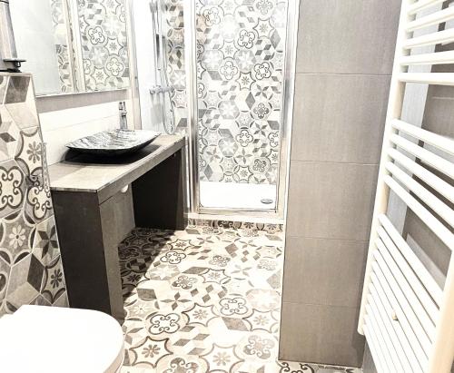 a bathroom with a shower with a sink and a toilet at Orsay - Beautiful flat in elegant part of Paris in Paris