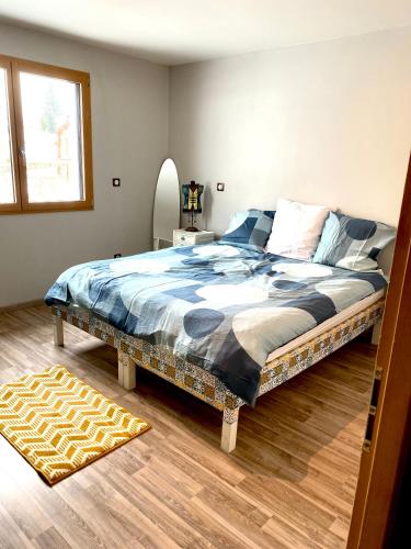 a bedroom with a large bed in a room at Maison chaleureuse au cœur du massif Jurassien in Saint-Pierre