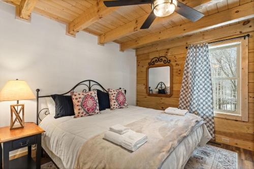 a bedroom with a large bed and a window at Cozy Rustic Cabin in Sugar Mountain