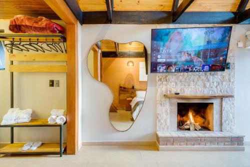 a living room with a fireplace and a bunk bed at Pousada das Pedras in Monte Verde