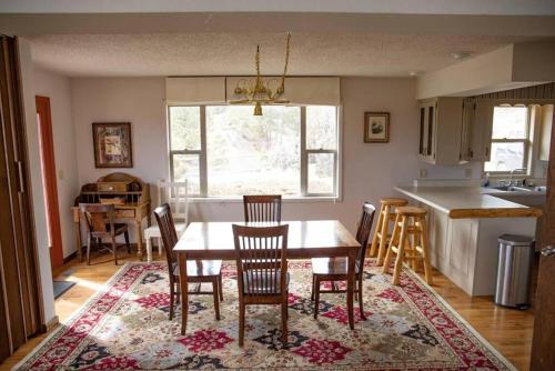a dining room and kitchen with a table and chairs at Private 313 Acre retreat/lakes/direct forest entry in Buena Vista