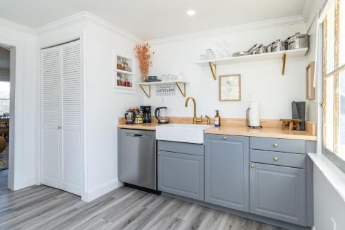 a kitchen with blue cabinets and a sink at Loft on Capital - Ideally located to Distilleries in Frankfort
