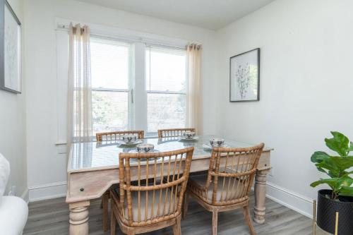 a dining room with a wooden table and chairs at Loft on Capital - Ideally located to Distilleries in Frankfort