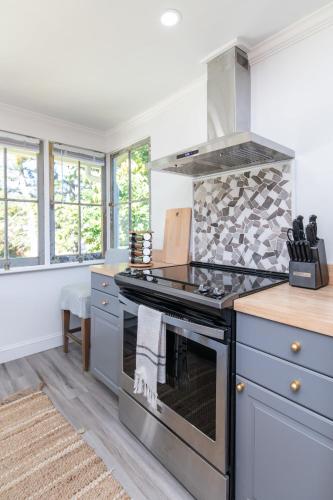 a kitchen with a stove and a counter top at Loft on Capital - Ideally located to Distilleries in Frankfort