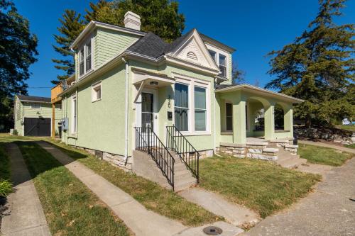 a green and white house on a street at Loft on Capital - Ideally located to Distilleries in Frankfort