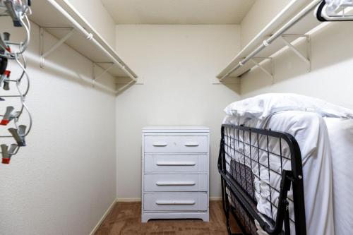 a walk in closet with a bed and a crib at Timeless-Texas-Inn - Heated Pool Oasis & Lux Vibe in Round Rock