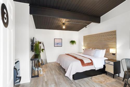 a bedroom with a bed and a wooden ceiling at South Bay Inn in Westport