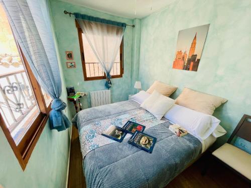 a bedroom with a bed with two pictures on it at VINO DE MAYO in Caravaca de la Cruz