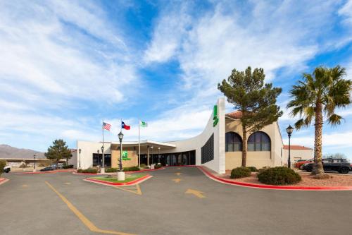 a building with flags in front of a parking lot at Holiday Inn El Paso West – Sunland Park by IHG in El Paso