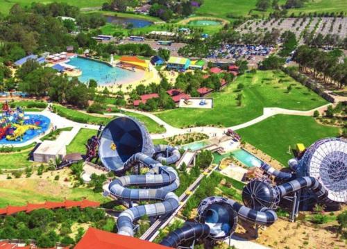 an aerial view of a water park with a roller coaster at Stylish Serenity at Sunrise in Fairy Meadow