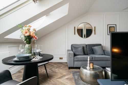 a living room with a couch and a table at Central Palace - LoftAffair Collection in Kraków