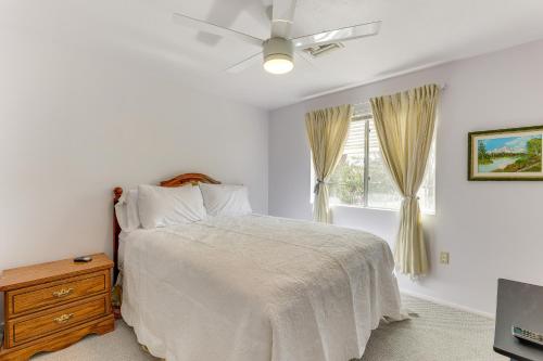 a white bedroom with a bed and a window at Convenient Mesa Apartment about 9 Mi to Downtown in Leisure World