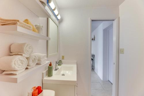 a white bathroom with a sink and a mirror at Convenient Mesa Apartment about 9 Mi to Downtown in Leisure World