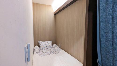 a small room with a bed in a closet at MAHHO TERRACE MIYAKO in Miyako Island