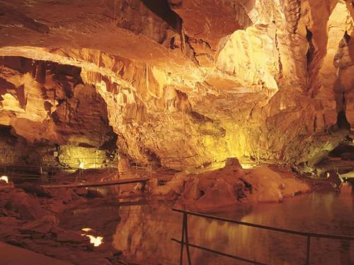 a cave with a pool of water in it at Maison chaleureuse au cœur du massif Jurassien in Saint-Pierre