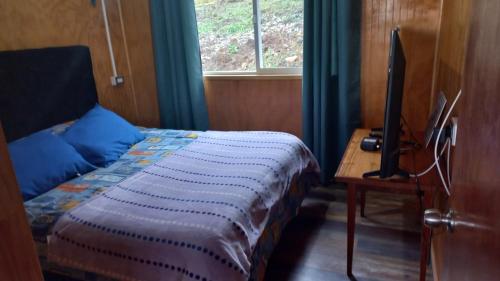 En eller flere senger på et rom på Cabaña del nino