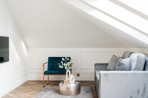 a living room with a couch and a chair at Central Palace - LoftAffair Collection in Kraków