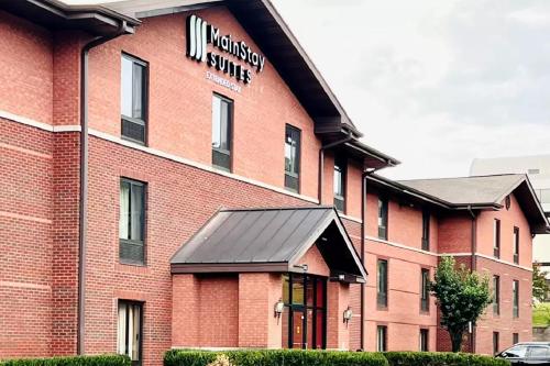 a red brick building with a sign on it at MainStay Suites Little Rock West Near Medical Centers in Little Rock