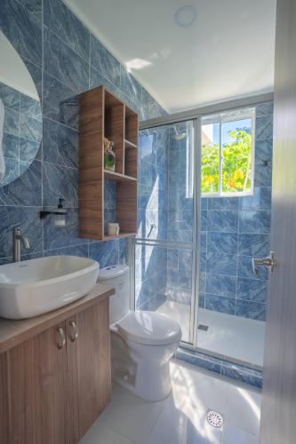 a bathroom with a toilet and a sink and a shower at Luxury Eco Apartament in Playa Aguadulce