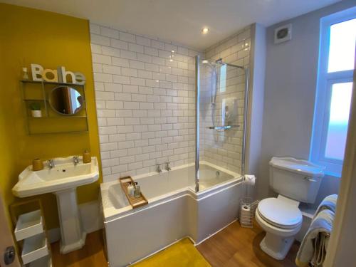 a bathroom with a toilet and a shower and a sink at Harbour Hideaway, Scarborough. Old Town in Scarborough