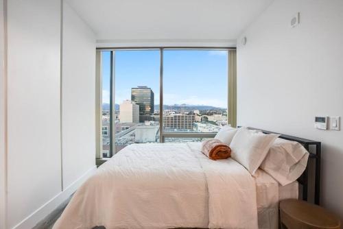 a bedroom with a bed and a large window at NEW 1BR Luxury Highrise in Los Angeles