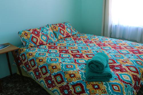 a bed with a blanket and a towel on it at Formerly the Blackball Hilton in Blackball