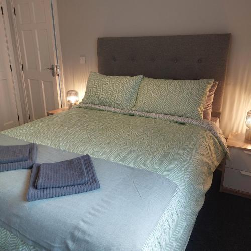 a bed with two pillows on top of it at Lawnbrook Town House in Belfast