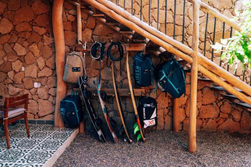 a wall with a bunch of bags and ski equipment at Las Dunas Beach Guest House in Juan de Acosta