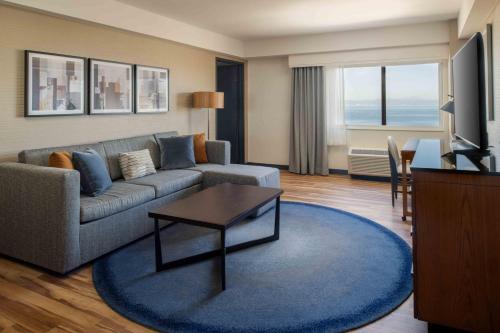 a living room with a couch and a table at DoubleTree by Hilton San Francisco Airport in Burlingame