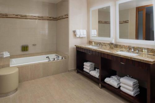 a bathroom with a tub and a sink and a bath tub at DoubleTree by Hilton San Francisco Airport in Burlingame