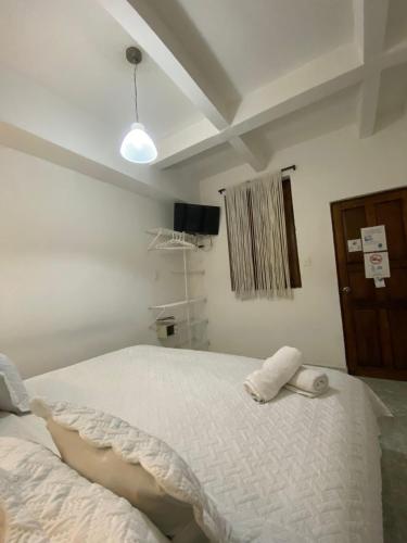 a bedroom with a large white bed in a room at Patio de Getsemani in Cartagena de Indias