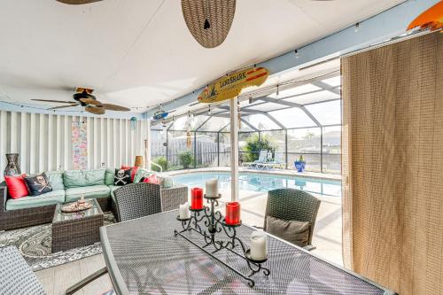 a living room with a table and a swimming pool at Port Charlotte Paradise with Private Outdoor Oasis! in Port Charlotte