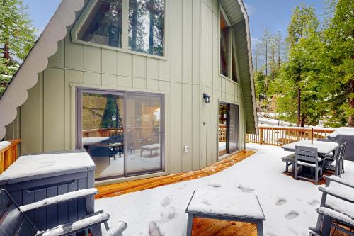 a house covered in snow on a patio at Groovy Days Chalet in Arnold