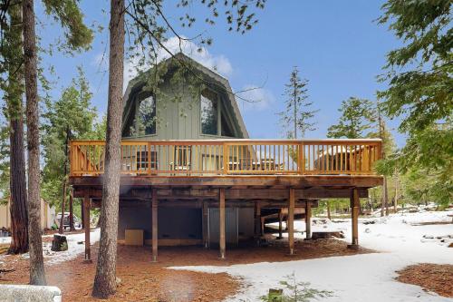 a wooden deck with a gazebo in the woods at Groovy Days Chalet in Arnold
