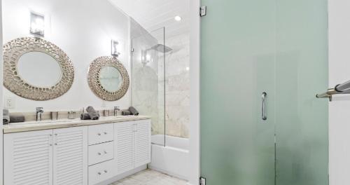 a bathroom with a shower and a sink and mirror at New Hidden Gem in Miami