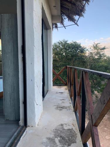 a balcony of a house with a fence at Casa Delfín Tulum in Macario Gomez