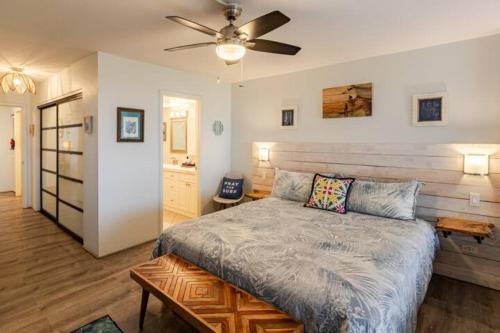 a bedroom with a bed and a ceiling fan at Hale Mai Hopohopo in Kahana