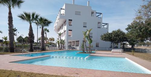 a swimming pool in front of a building at Easy Rent Management 292 in Roldán