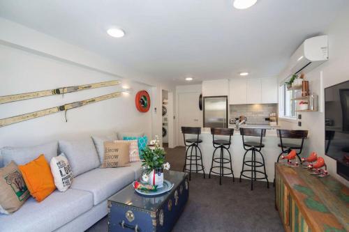 a living room with a couch and a bar at Hillside Villa 2- Walk To Town- AC- Free Parking in Queenstown