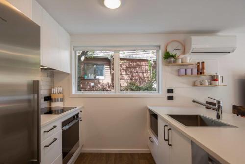 a kitchen with a sink and a window at Hillside Villa 2- Walk To Town- AC- Free Parking in Queenstown