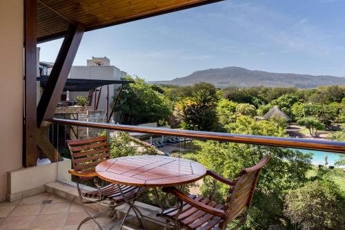 d'une terrasse avec une table et des chaises sur un balcon. dans l'établissement Arabella Hotel, Golf and Spa, à Kleinmond