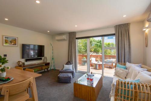 a living room with a couch and a table at Hillside Villa 3- Walk To Town- AC- Free Parking in Queenstown