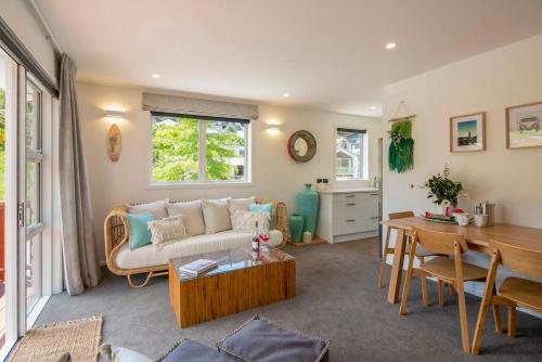a living room with a couch and a table at Hillside Villa 3- Walk To Town- AC- Free Parking in Queenstown