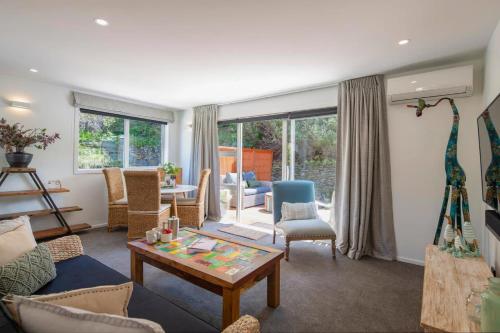 a living room with a giraffe on the wall at Hillside Villa 4- Walk To Town- AC- Free Parking in Queenstown