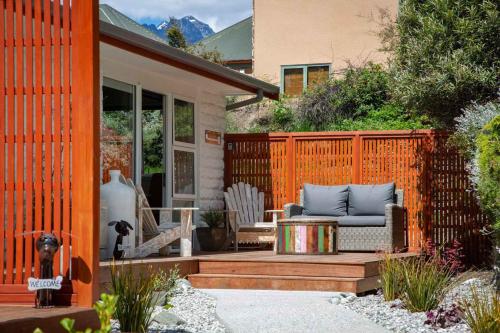 a patio with a couch on a wooden deck at Hillside Villa 4- Walk To Town- AC- Free Parking in Queenstown