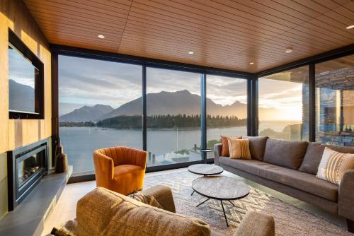 a living room with a view of the water and mountains at Lakehouse 3- Free Parking- Walk To Town- Air Con in Queenstown