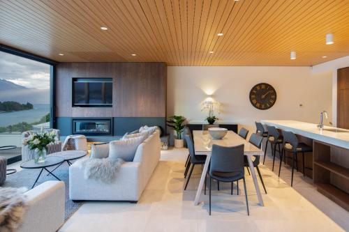a kitchen and living room with a table and chairs at Lakehouse 4- Free Parking- Walk To Town- Air Con in Queenstown