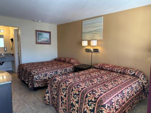 a hotel room with two beds and a couch at Sea Palace Motel in Seaside Heights