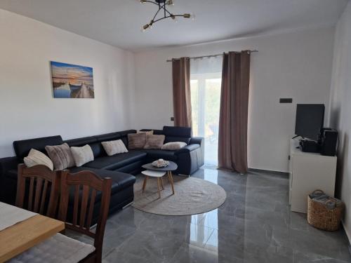 a living room with a couch and a table at Villa JaNi in Donja Jagodnja
