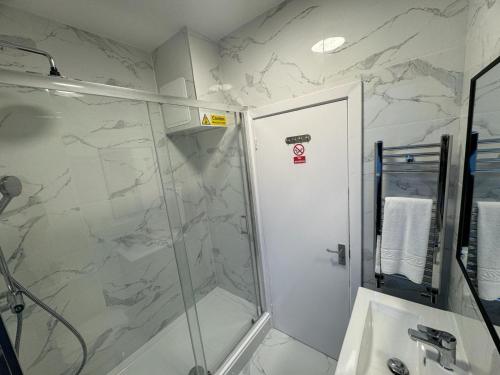 ein Bad mit einer Dusche und einem Waschbecken in der Unterkunft Camden Town Apartment in London